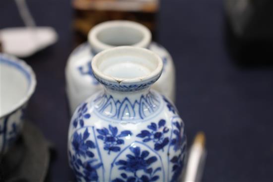 A Chinese blue and white tea bowl and saucer and two jars, Kangxi, some damage, largest diameter 11cm